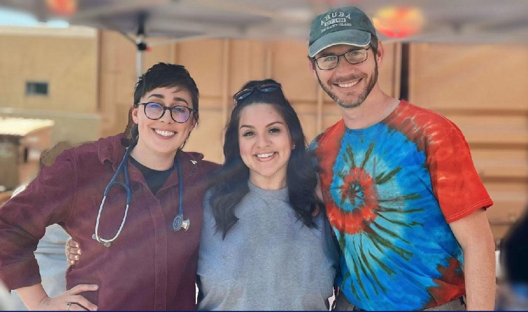 three people standing side by side one with a stethoscope around her neck