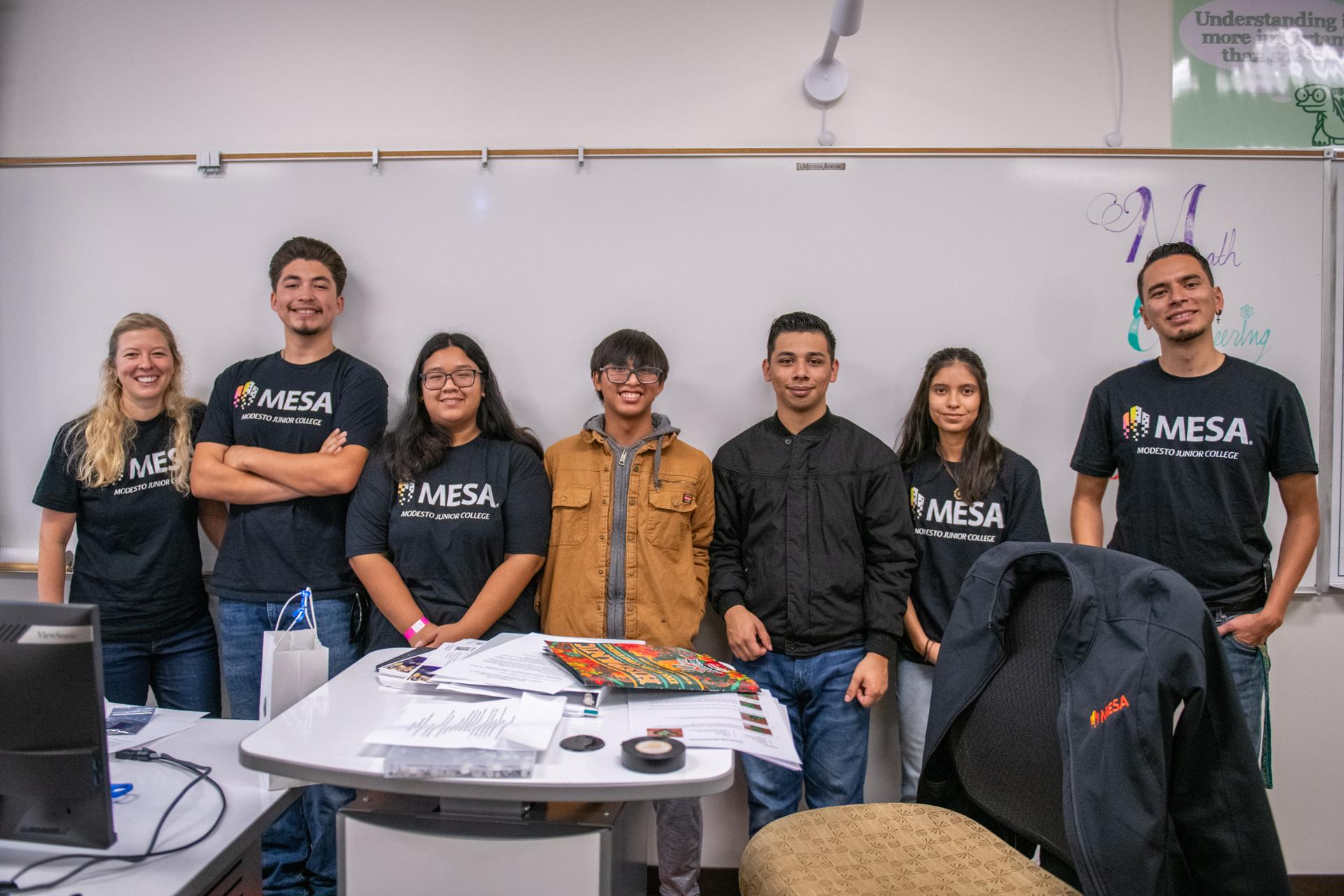 MESA students standing in front of a white board in classroom