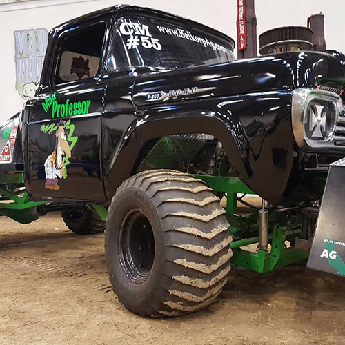 The Mad Professor, a huge black, green and chrome truck is covered with decals, and sports giant high-traction tires